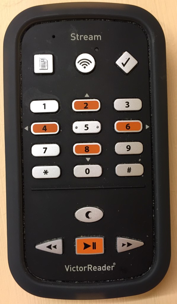 Victor Reader Stream Audio Player. Front view. Has a numeric keypad in the centre, play, search and sleep buttons at the bottom, and three more buttons at the top for other settings.