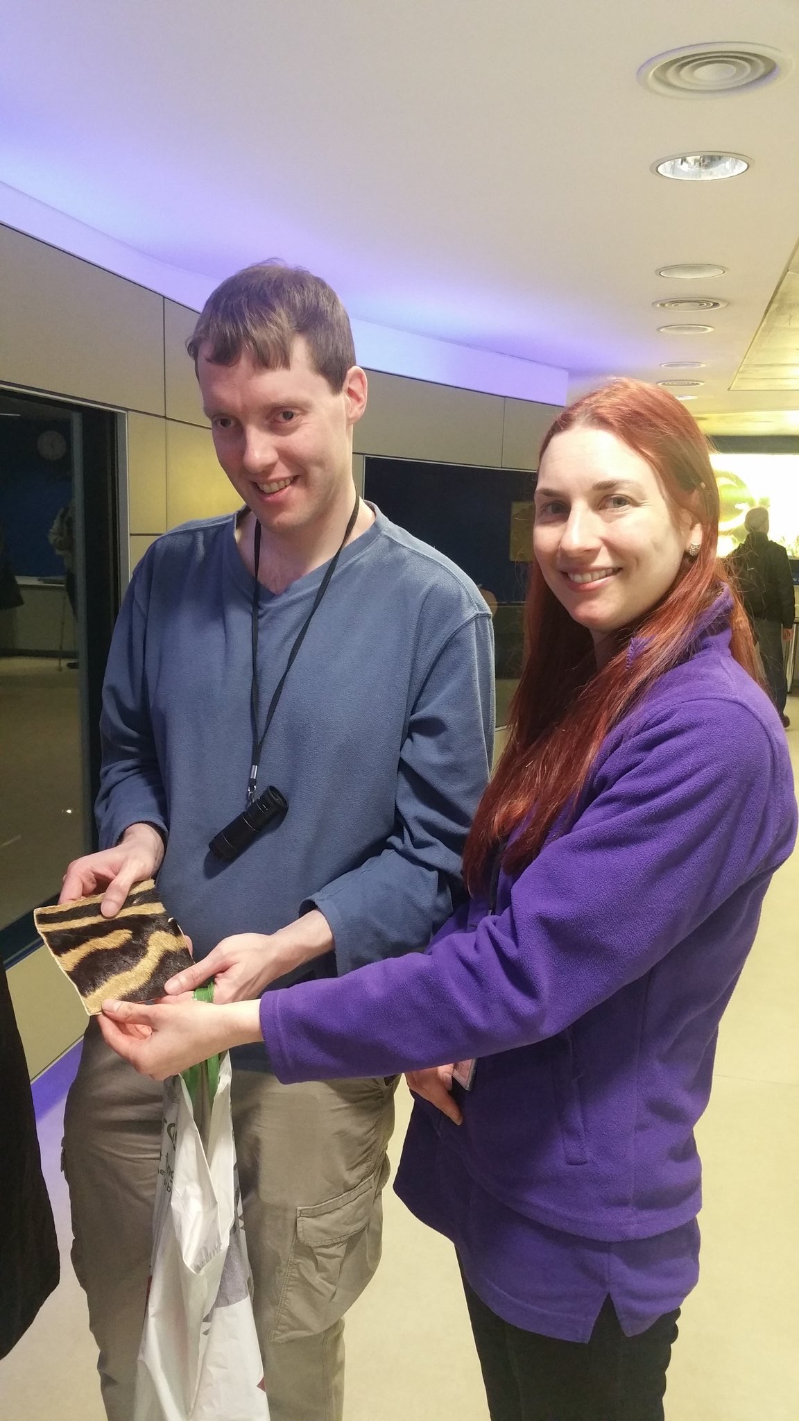 Glen holding a square piece of zebra fur with Sarah, one of the guides at the Natural History Museum.