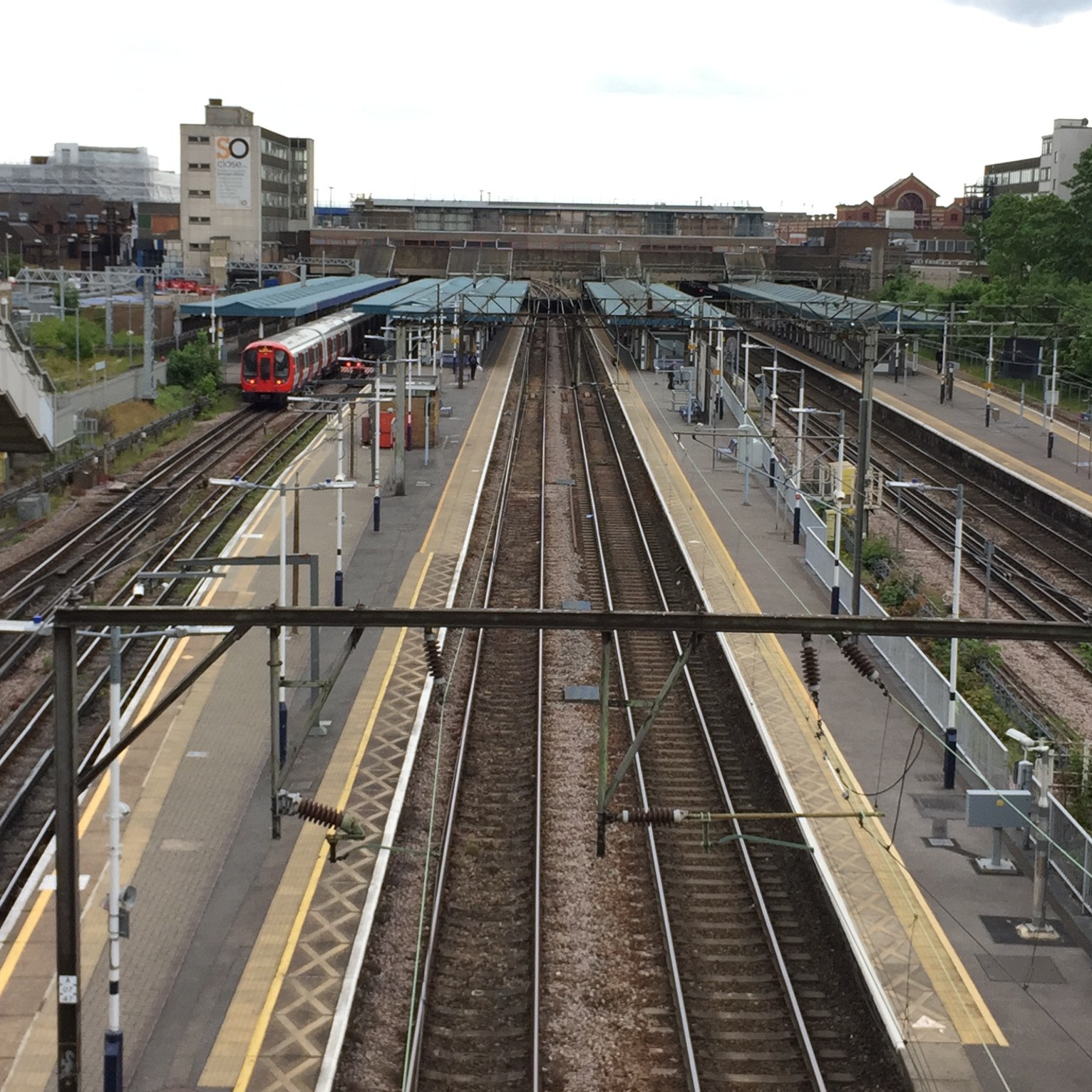 Overhead view from a bridge of the railway tracks and platforms at Barking Station.