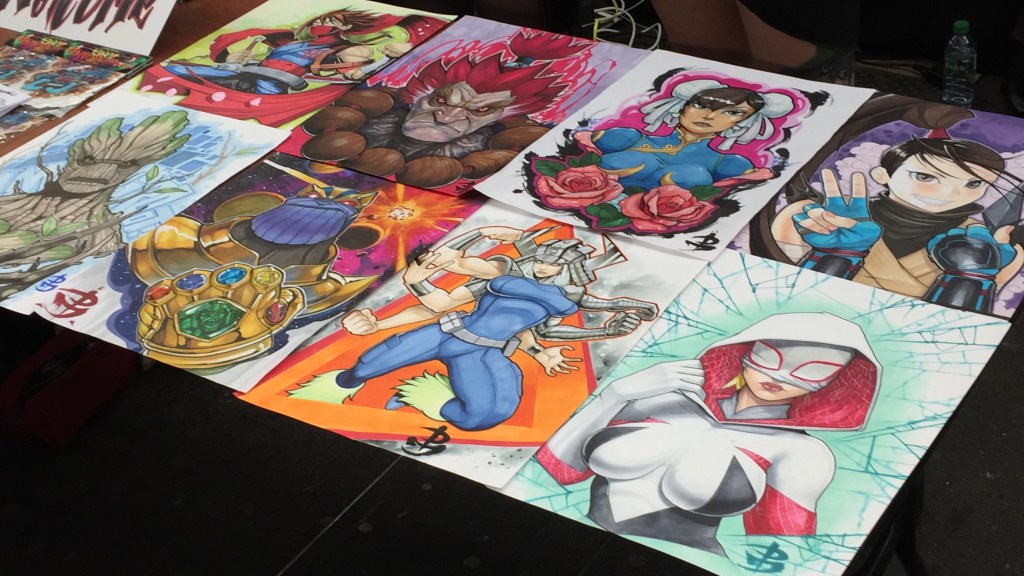Table laid out with anime inspired tattoo designs