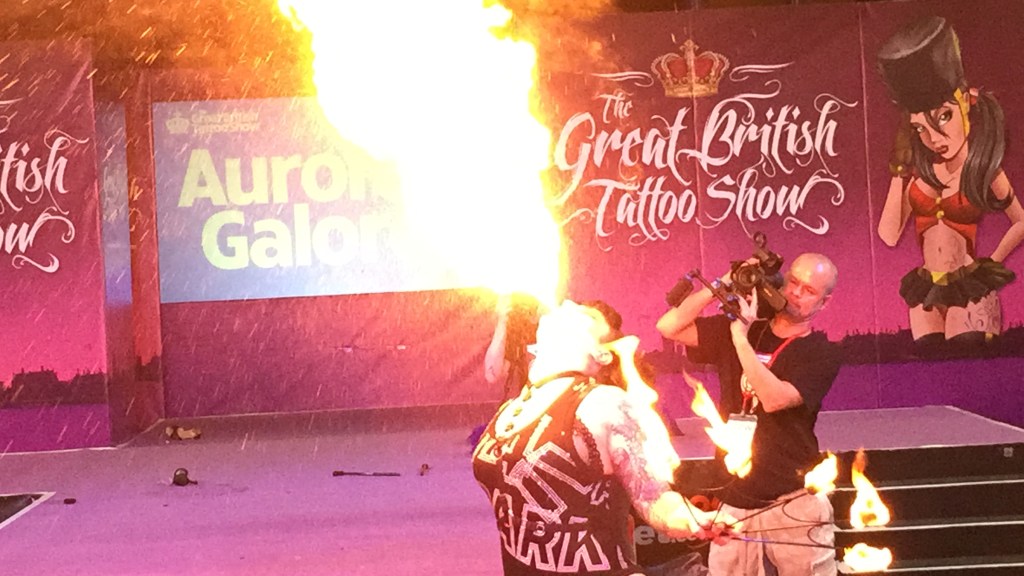 Burlesque dancer Aurora Galore blowing a huge fireball