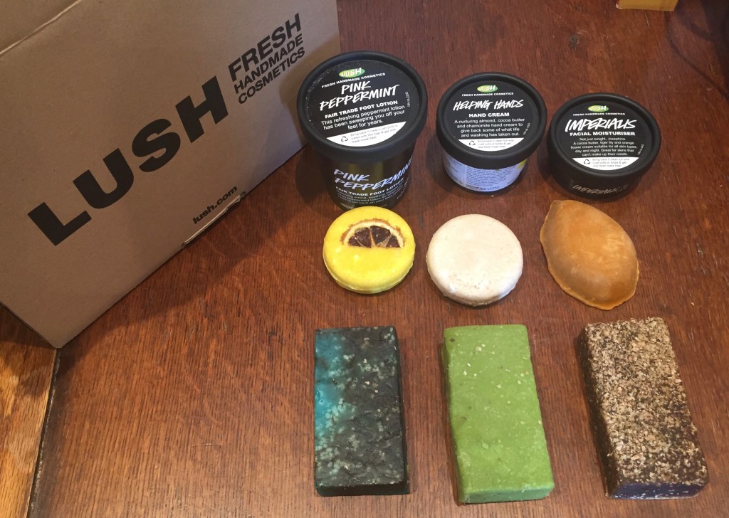 9 Lush products - 3 tubs, 2 round soaps, a pumice stone shaped soap, and 3 rectangular soap bars.