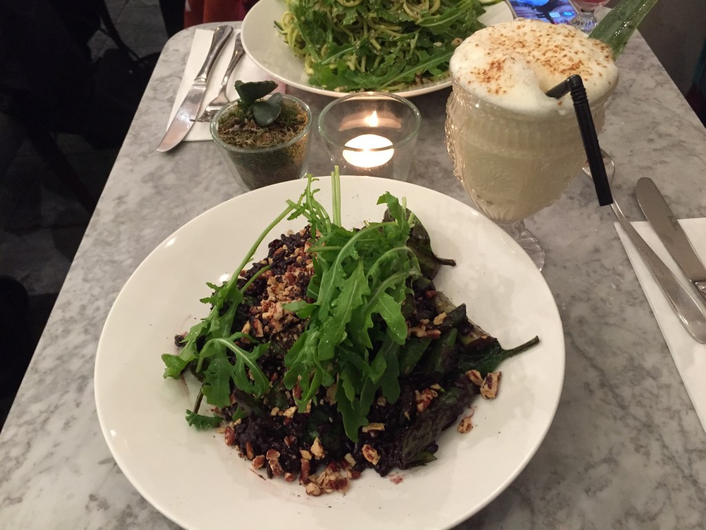 My large plate of asparagus & spinach black rice risotto, with a frothy white coconut and pineapple pina colada cocktail