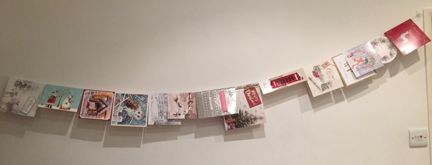 Christmas cards hung over a length of string along the wall.