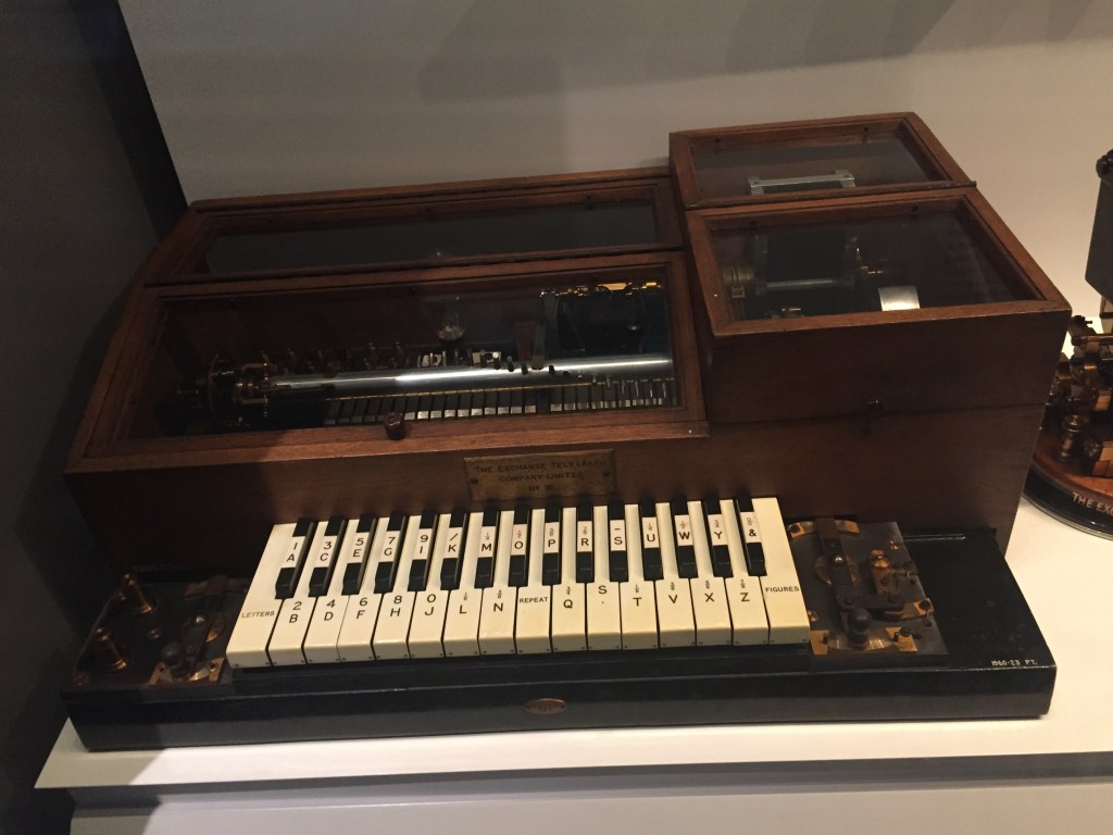 Large wooden box with black and white piano keys on the front, which consistently alternate like a piano, but without gaps in the black keys like you would expect. The far left and right white keys specify letters or numbers, then the others show letters, numbers or other symbols. So the first black key is 1 or A, the next white key is 2 or B, the next black key is 3 or C, and so on.