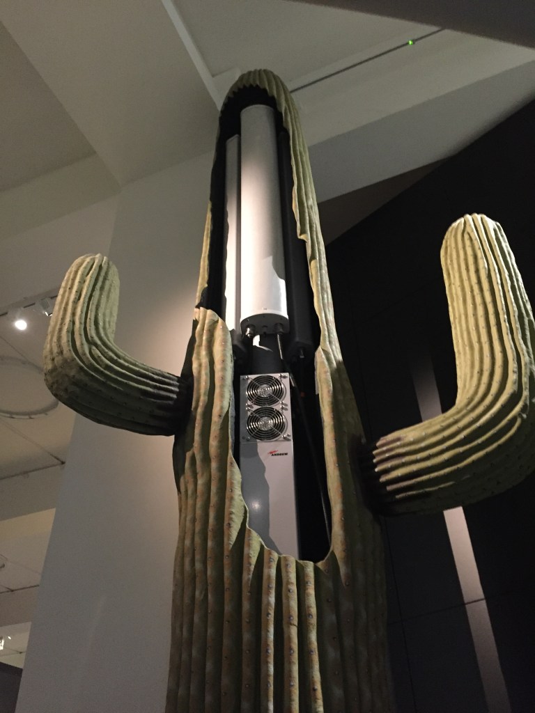 A huge, tall model of a cactus, with the central tower cut open to reveal machinery inside for a mobile phone mast.