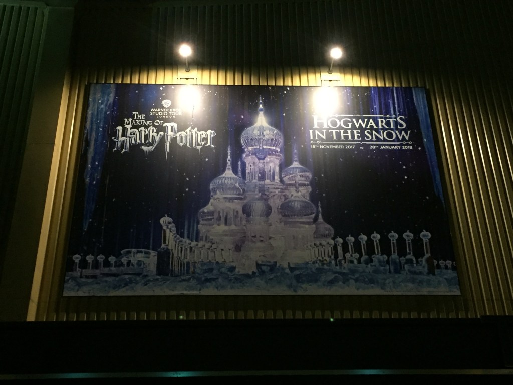 Poster of a big ice castle sculpture in front of a starry night sky. The top left of the poster has the Making Of Harry Potter Logo, while the top right has the text Hogwarts In The Snow.