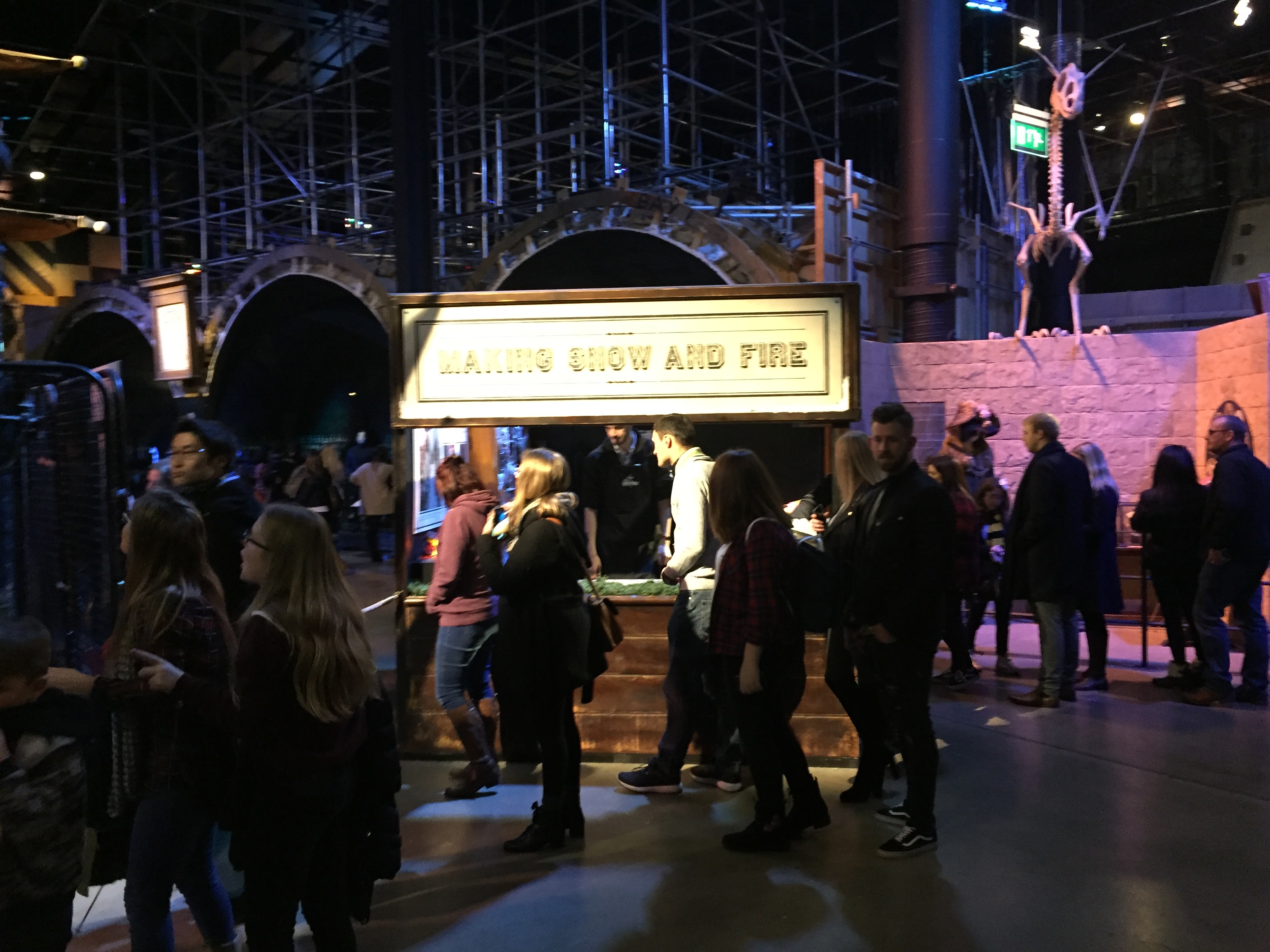 People walking by a stand with the heading Making Snow And Fire above it, where you can feel the materials used to make those effects.