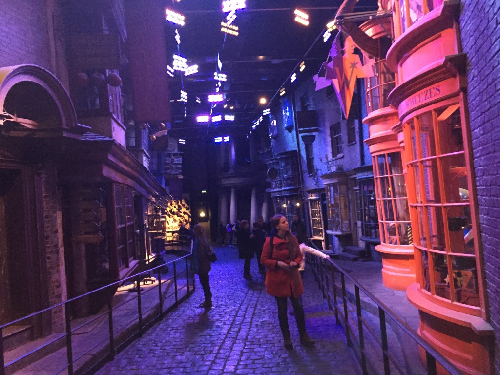 View down set of Diagon Alley towards Gringotts Bank at the far end. Studio lights above illuminate the street.