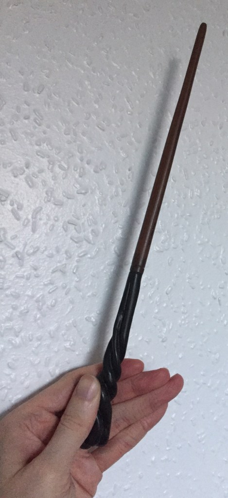 Neville Longbottom's wand, the bottom end sculpted in a swirling patten that goes round and round the wand.