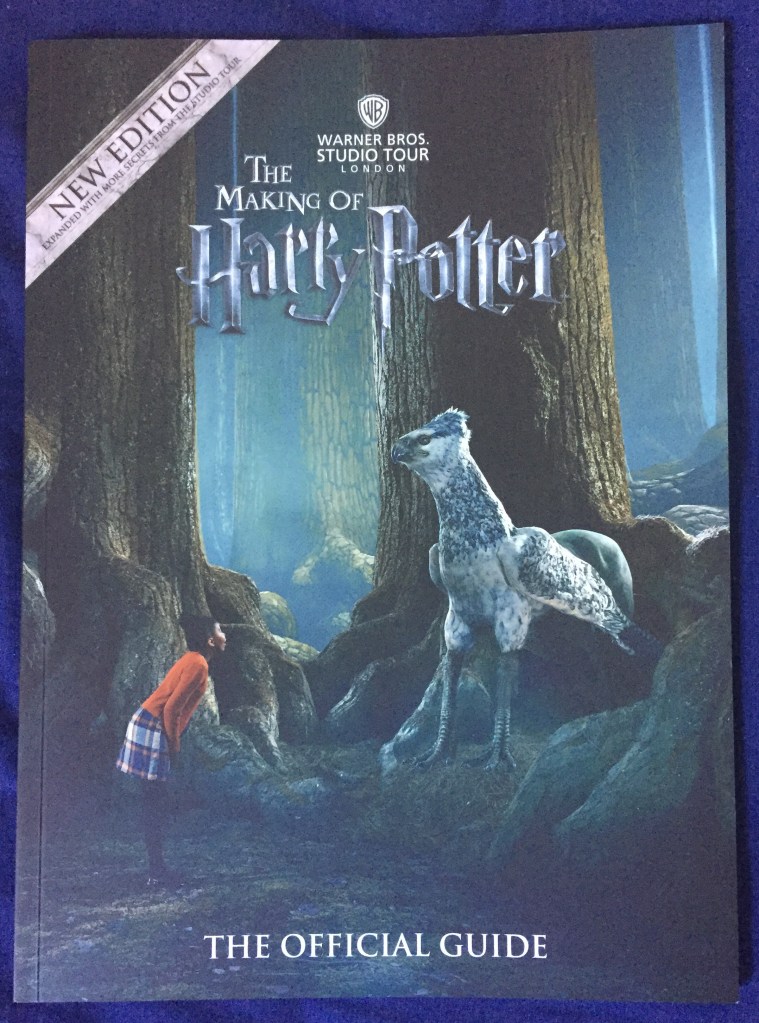 The Making Of Harry Potter Official Guide Book. Cover shows a scene in the Forbidden Forest, with a young girl looking up at Buckbeak the Hippogriff in front of her, as if talking to him.