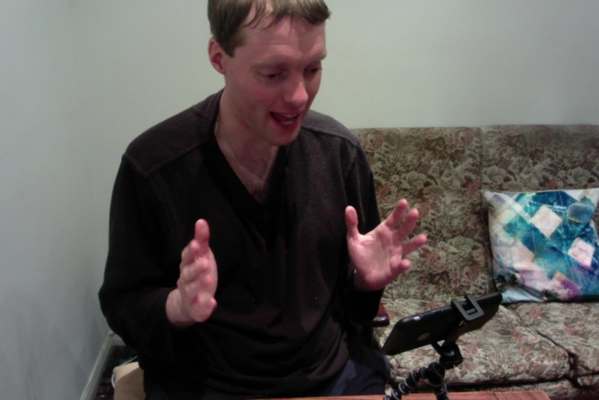 Me recording a video, using my iPhone that’s on a tripod on the table in front of me.