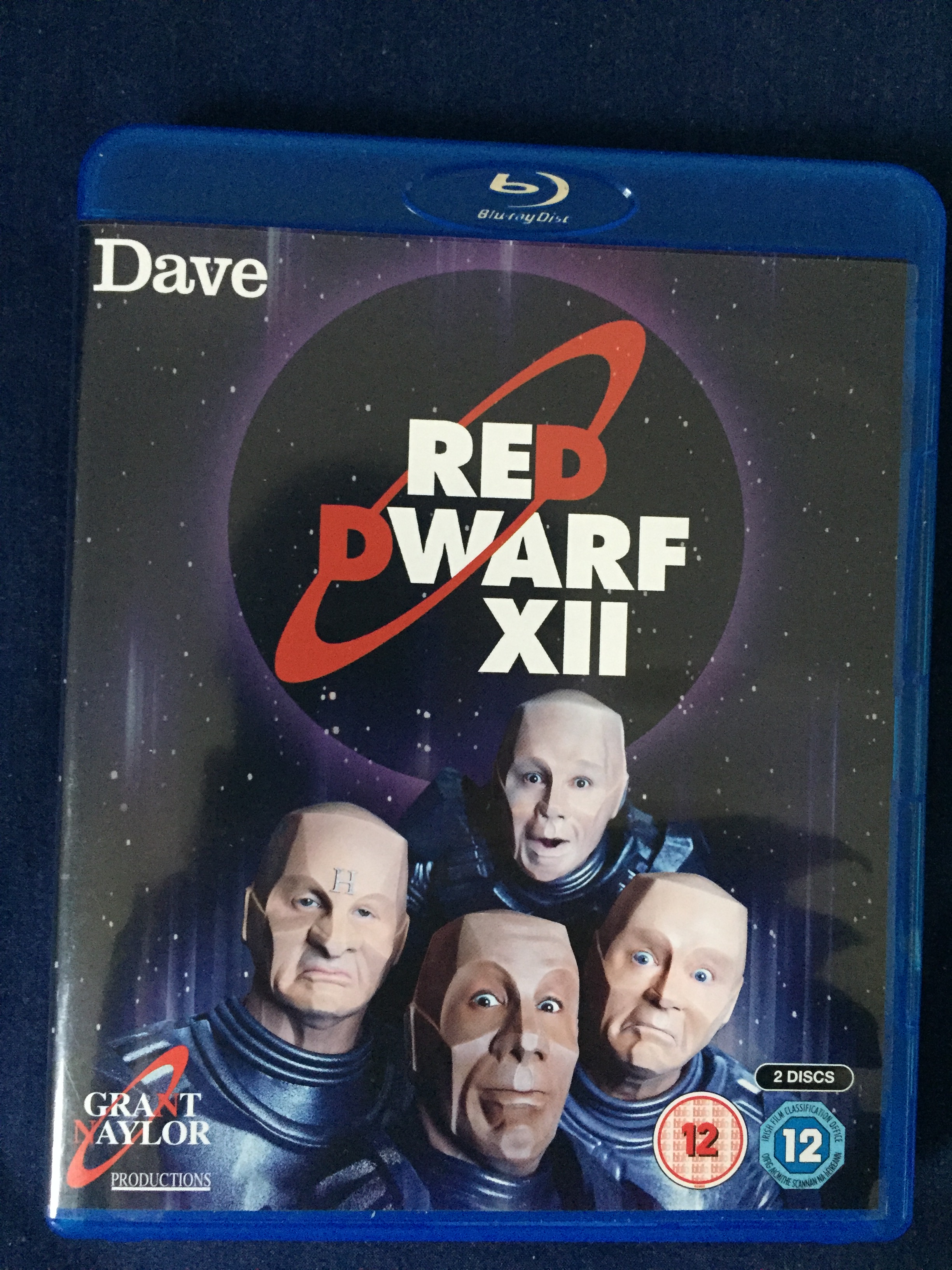 Front of the Blu-ray case for Red Dwarf series 12, showing the 4 members of the crew all in mechanoid form like Kryten.