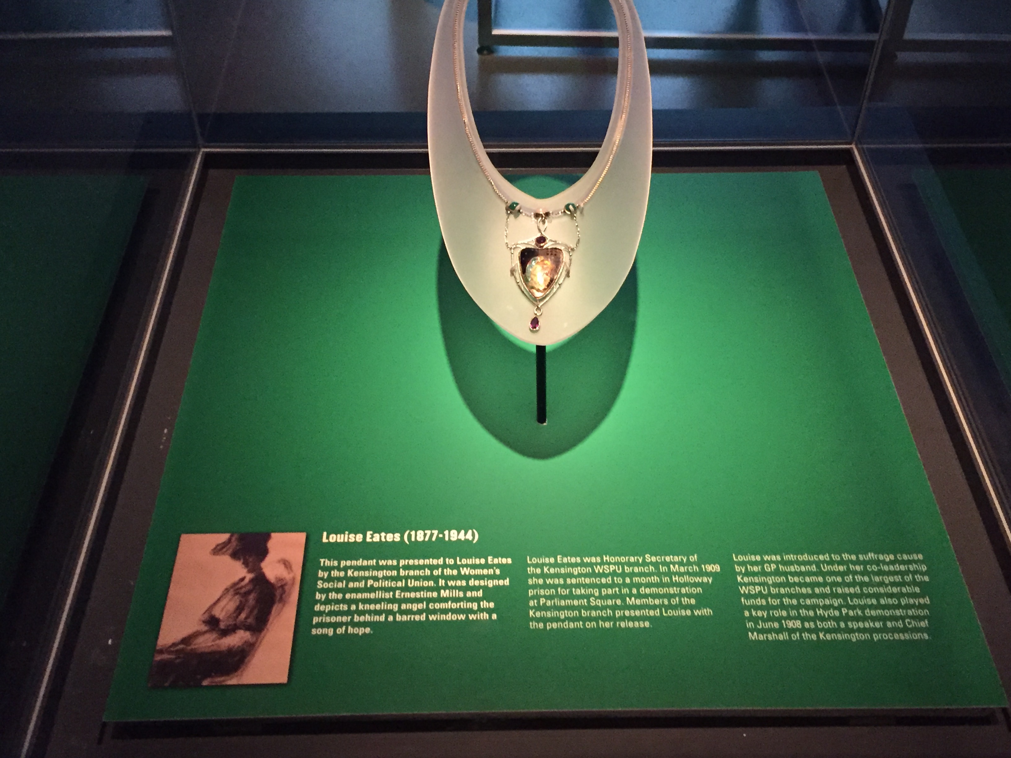 Gold coloured pendant presented to suffragette Louise Eates