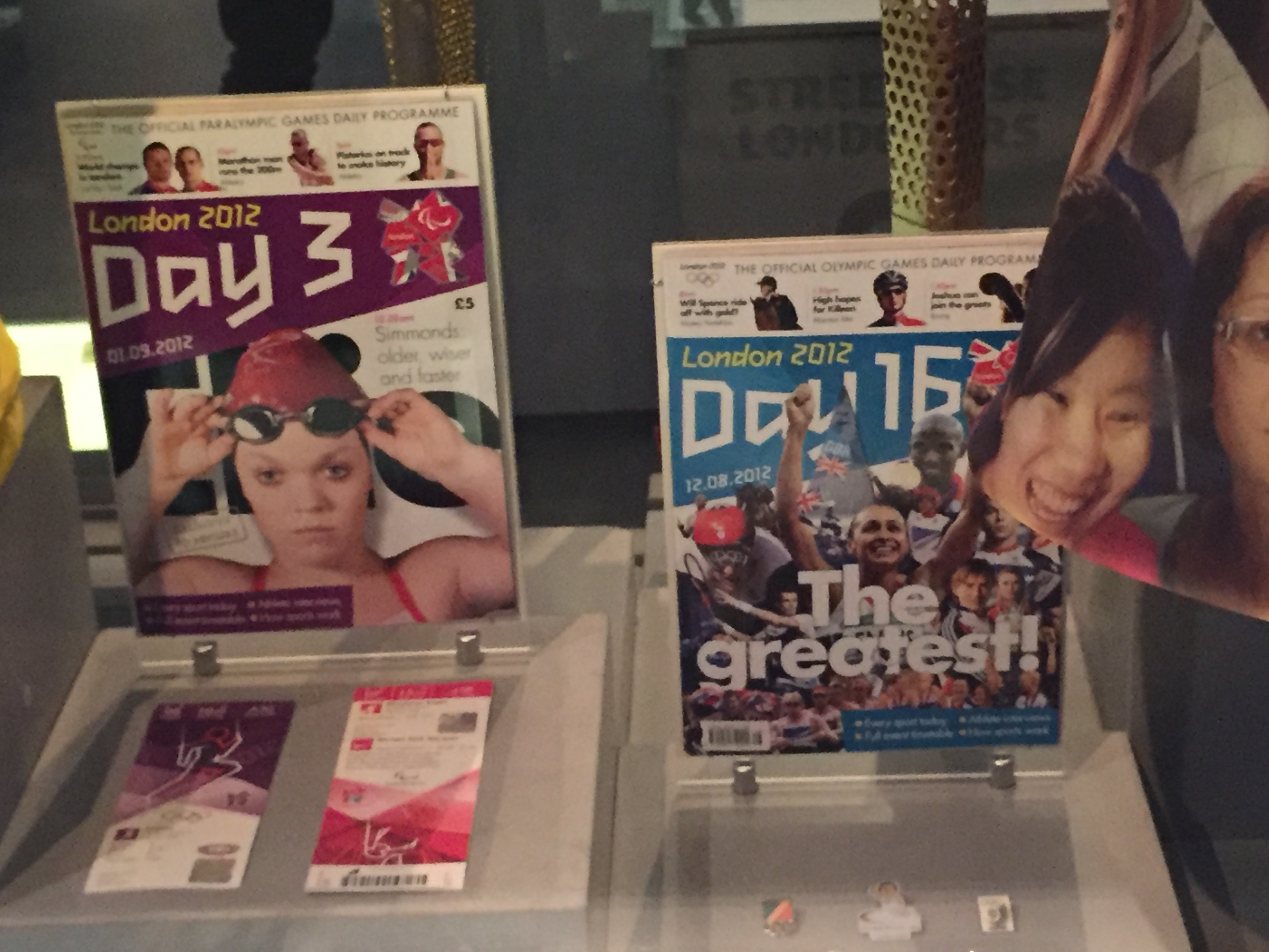 Souvenir guides from London 2012 - one for day 3 of the Paralympics, with Ellie Simmonds lifting her goggles on the cover, and the other for day 16 of the Olympics, with gold medal winners including Jessica Ennis, Mo Farah and others, declared as The Greatest by the headline.