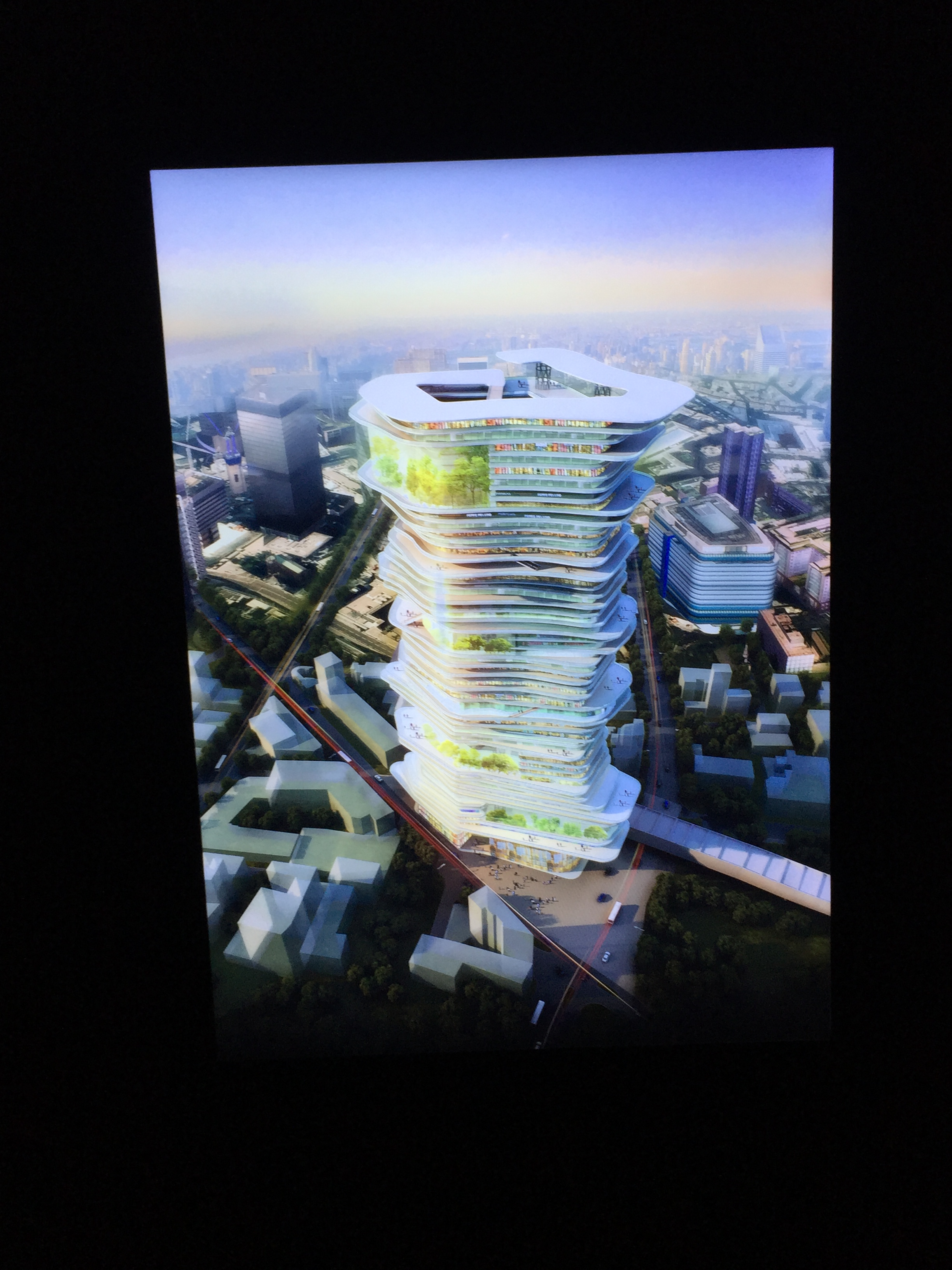 Artist's vision of a an unusual skyscraper in future London. The tall building has an unusual shape, curving in and out irregularly all the way around, and is made up of lots of very thin floors, as if it's a big pile of papers.