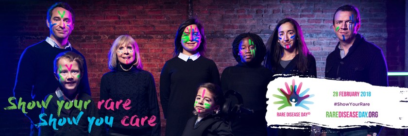 A group of 8 people, of varying age, gender and race, wearing luminous face paint. In the bottom left corner are the colourful words Show Your Rare, Show You Care. On a white banner in the bottom right corner is the Rare Disease Day logo, and colourful text saying 28 February 2018, Show Your Rare, RareDiseaseDay.org.
