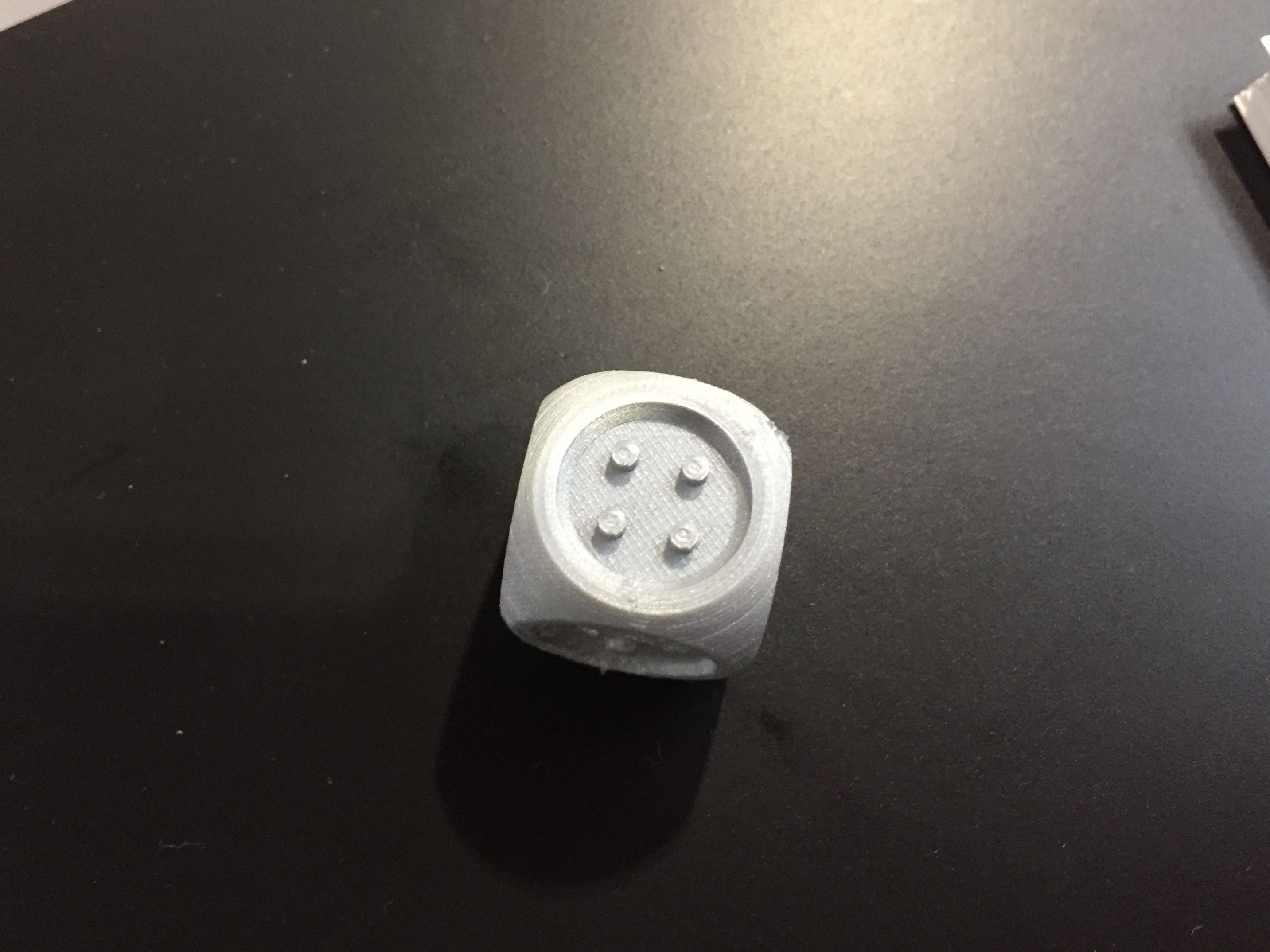 Grey 3D printed dice with tactile dots