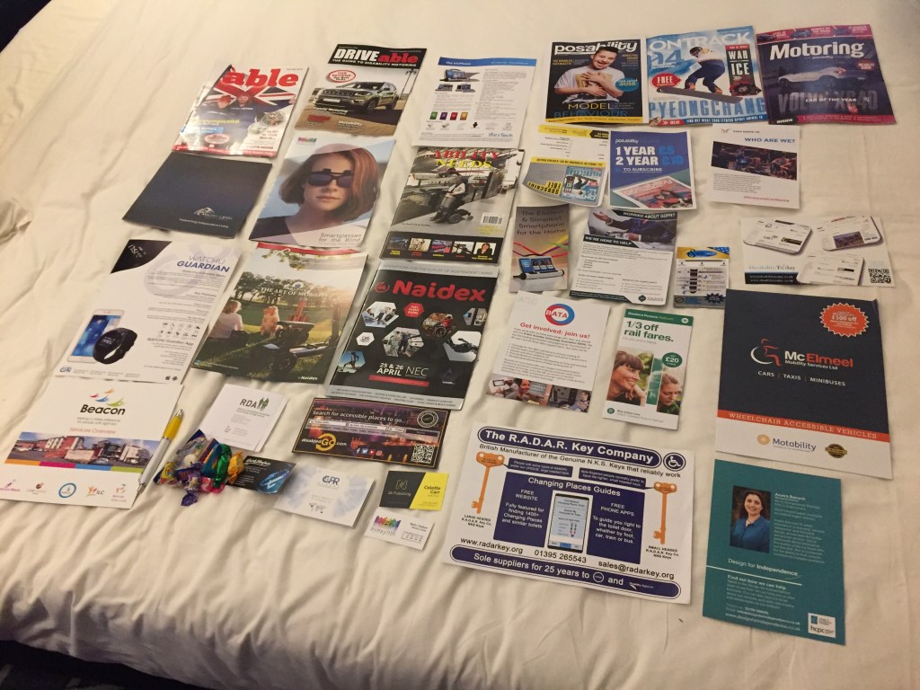 Lots of magazines, leaflets, flyers and business cards from the Naidex show spread all over my hotel bed.