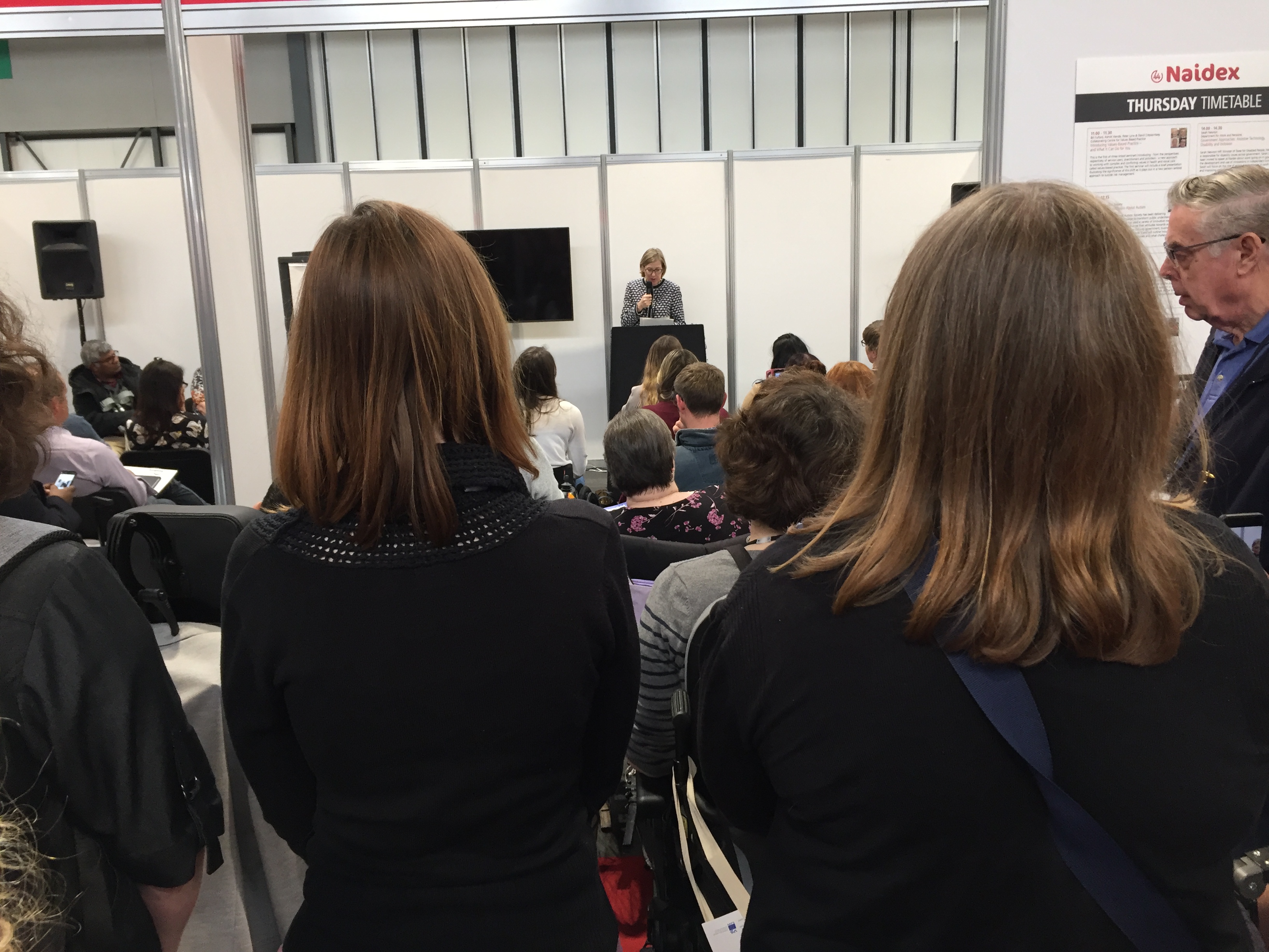 Large crowd of people watching Sarah Newton's talk