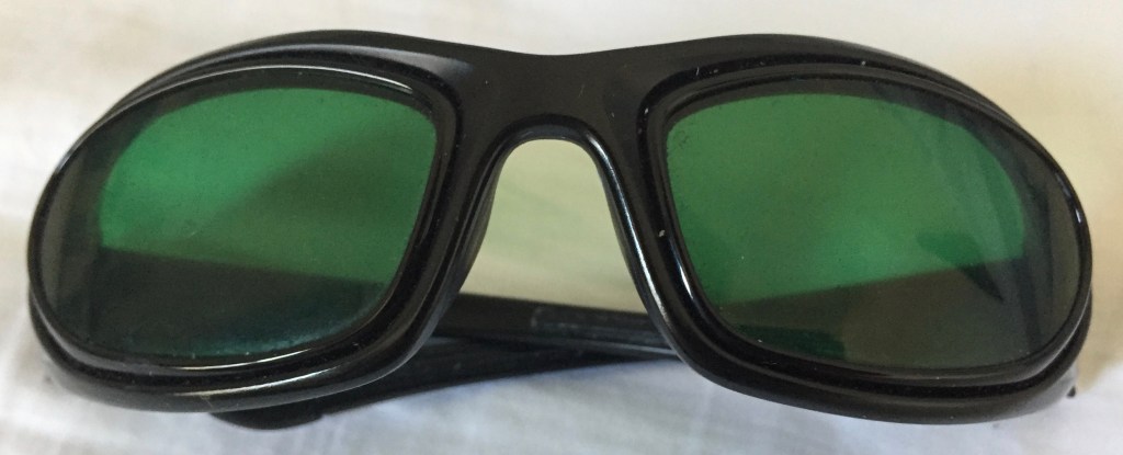 Green tinted sunglasses with a black frame