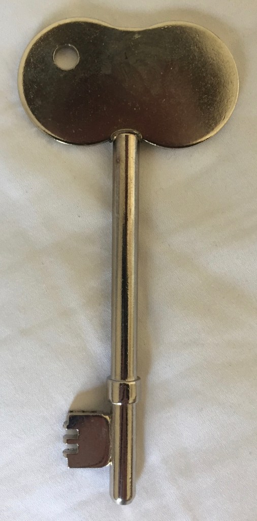 A RADAR key, which is just a large silver key with a large rounded head.