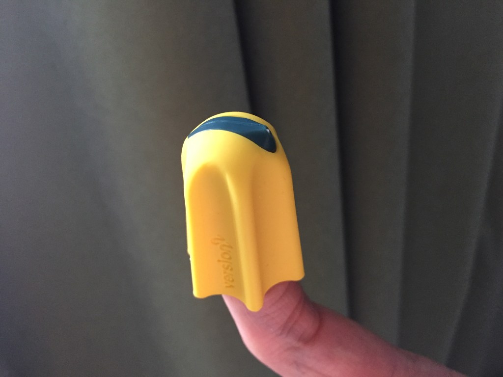 The Nimble cutter is a yellow rubber thimble, with a thin black strip across the top ending in a small point. This allows you to slide your finger along something to cut a line and open it, instead of using scissors.