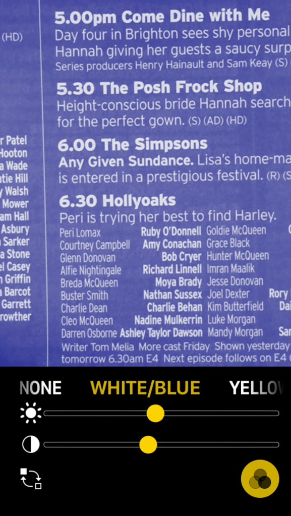 iPhone screenshot of the Magnifier app. It is being used to read the schedule for Channel 4 in a TV guide magazine, using a colour setting that gives white text on a blue background.