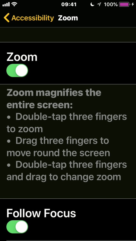 iPhone screenshot of the Zoom menu, explaining the gestures - double-tap 3 fingers to zoom, drag 3 fingers to move round the screen, and double-tap 3 fingers then drag to change teh zoom.