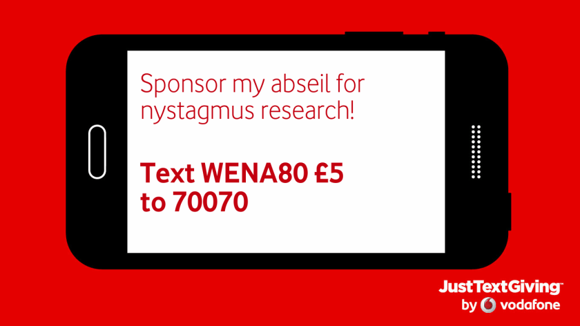 A image of a black smartphone against a red background. The white screen of the phone, on its side in landscape mode, has red text saying Sponsor my abseil for nystagmus research! Text WENA80 £5 to 70070. In the bottom right corner of the red background is a credit for Just Text Giving by Vodafone.