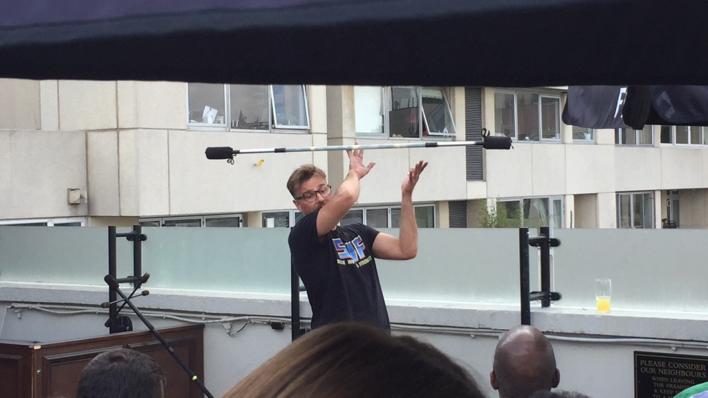 Juggler spinning a stick over his head.
