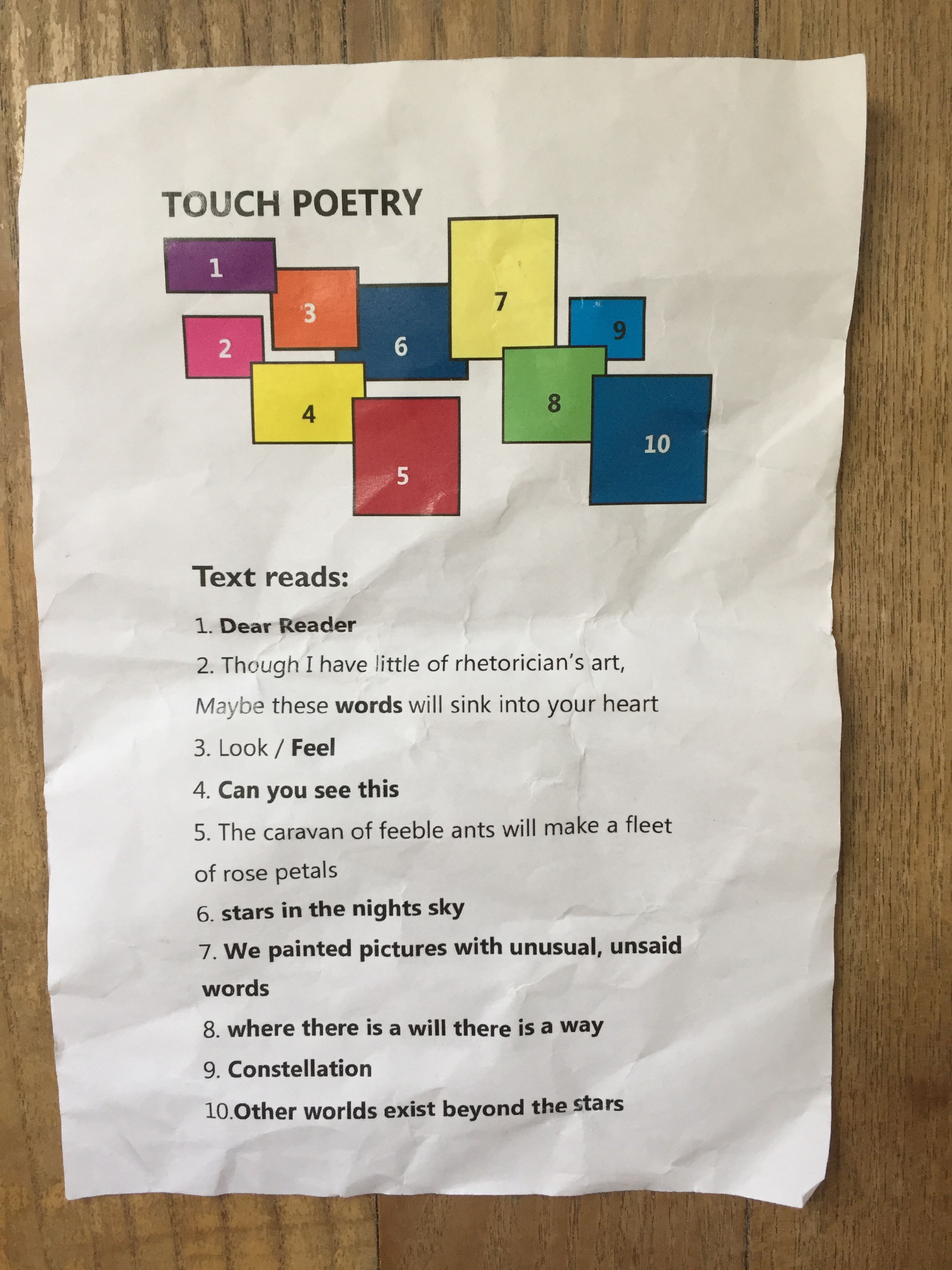 Leaflet translating the Braille artwork. Dear Reader. Though I have little of rhetorician's art, maybe these words will sink in to your herat. Look, feel. Can you see this. The caravan of feeble ants will make a fleet of rose petals. Stars in the night sky. We painted pictures with unusual, unsaid words. Where there is a will, there is a way. Constellation. Other worlds exist beyond the stars.