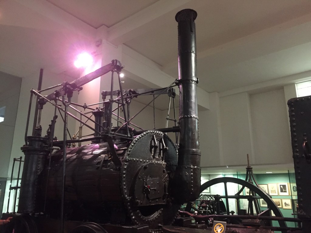A large steam engine with a very tall chimney.