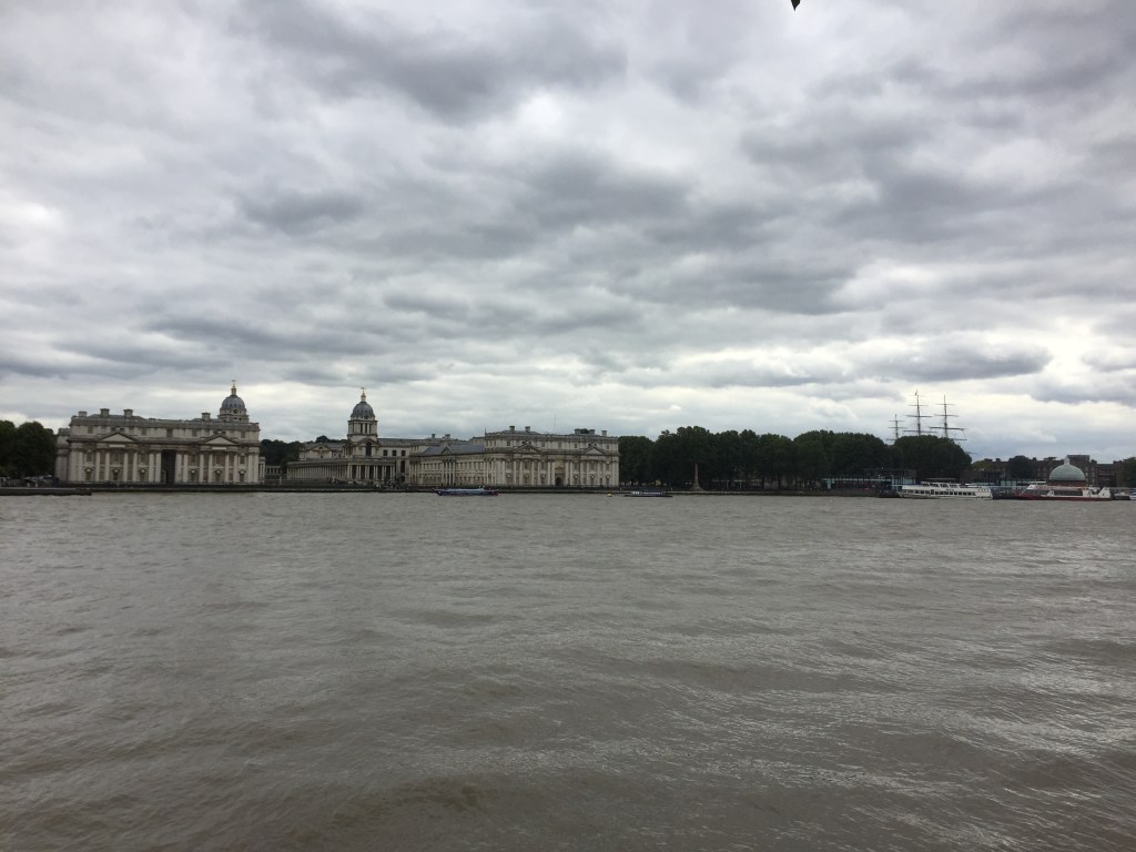 View across the River Thames from Island Gardens, looking at the Old Royal Naval College and Cutty Sark ship.