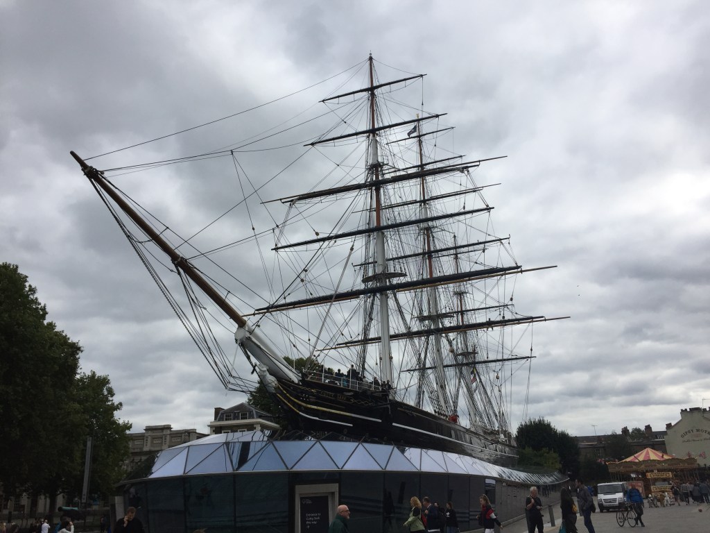 The Cutty Sark, a long ship with 3 huge rigging towers for the sails.