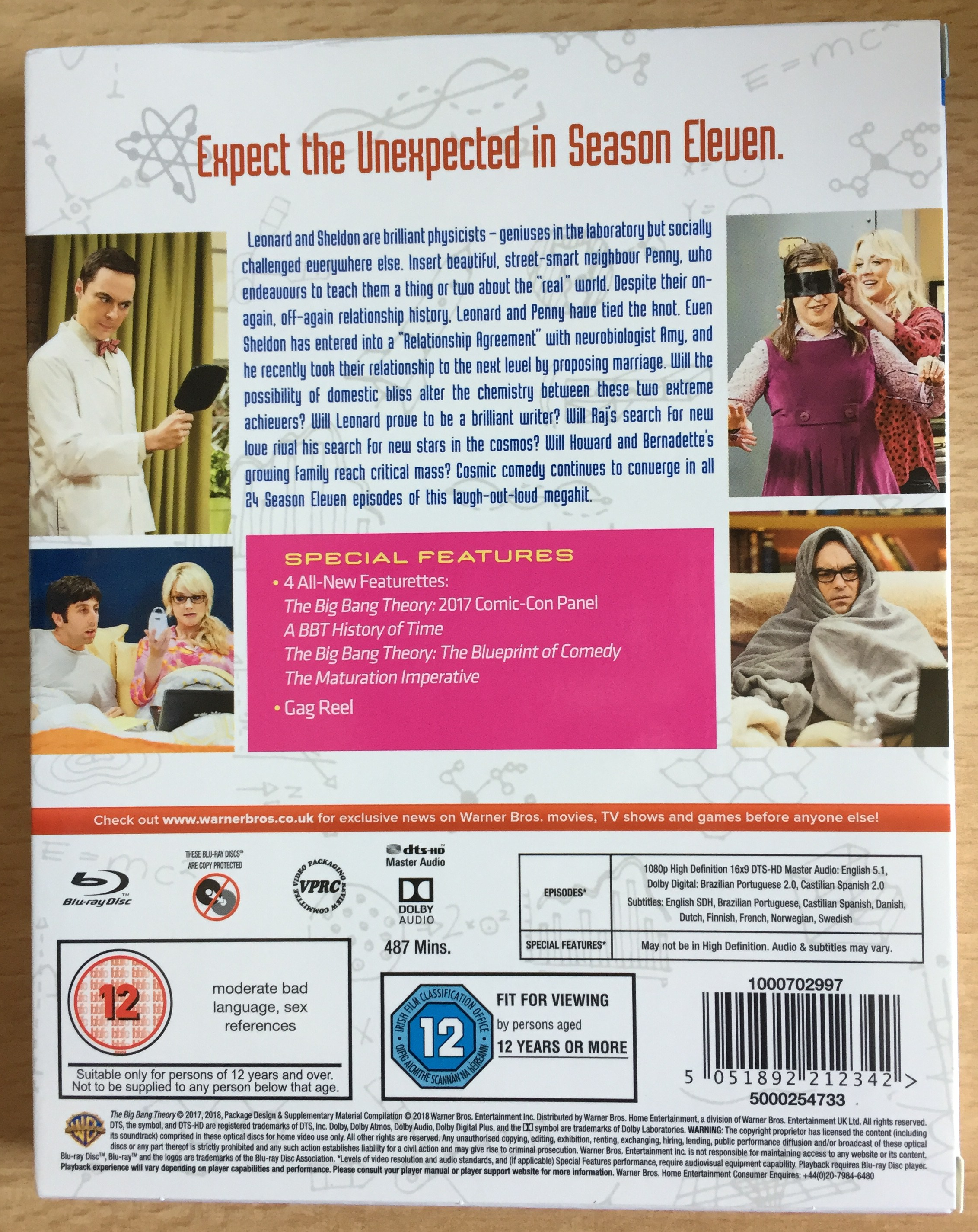 Back cover of the Blu-ray for The Big Bang Theory Season 11, with a synopsis of the show and photos from the episodes. Special features include featurettes called A History Of Time, The Blueprint Of Comedy and The Maturation Imperative, along with their 2017 Comic-Con panel and a gag reel.
