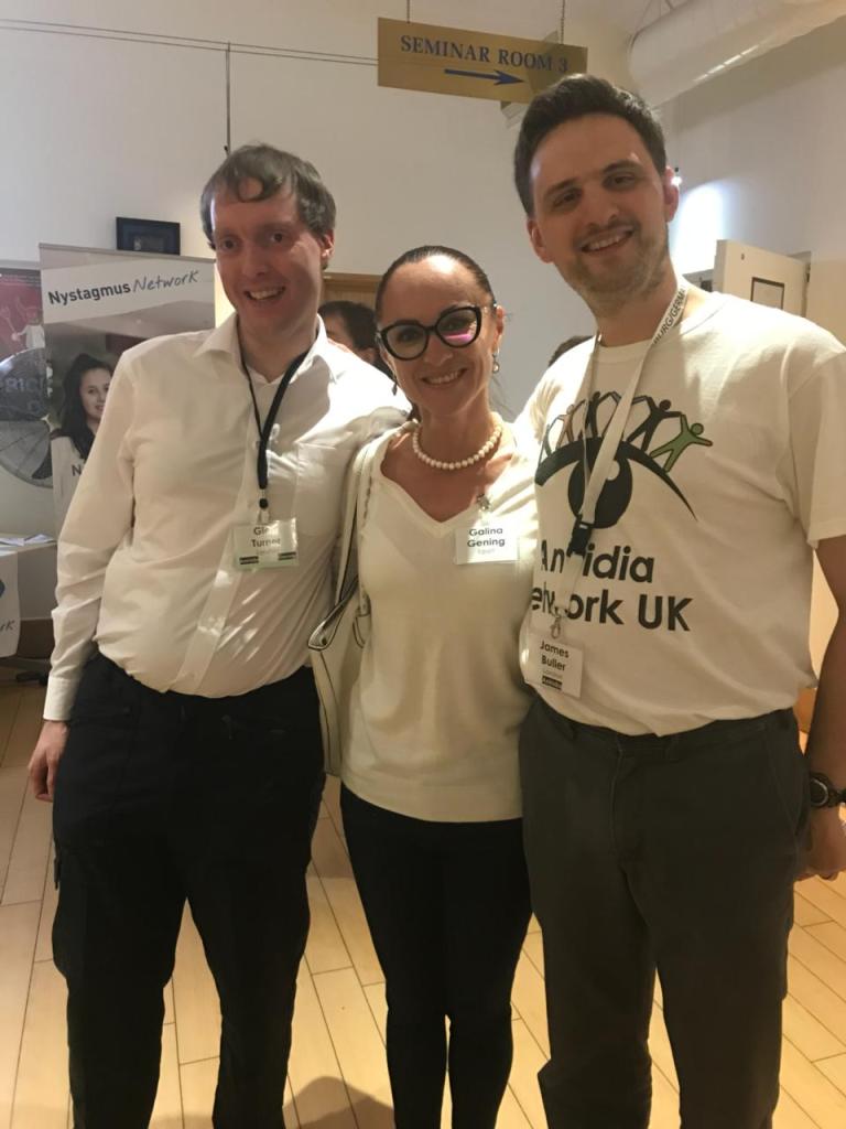 Glen, Galina and James posing and smiling together at the Aniridia Network Conference.