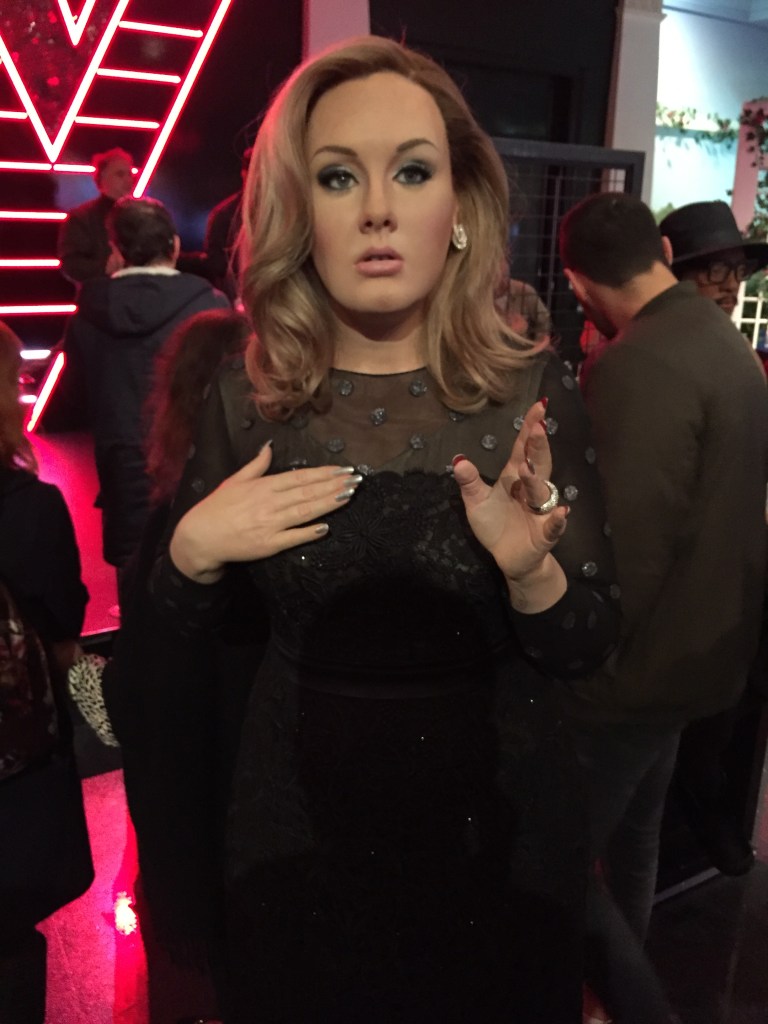 Madame Tussauds waxwork of Adele wearing a black dress.