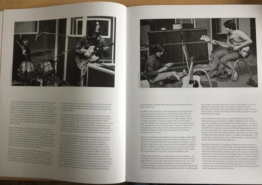 2 pages in the book for the White Album box set, each showing 2 columns of text below a photo of The Beatles performing in the studio.