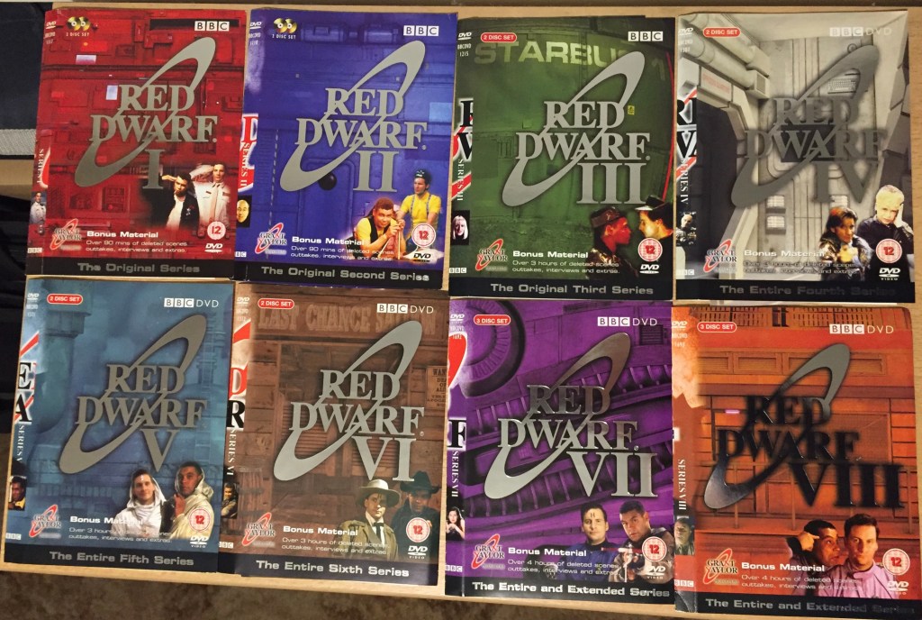 DVD covers for the original Red Dwarf series 1 to 8 DVD releases. Each cover has a large silver version of the Red Dwarf logo against a different coloured background, with different characters from the show in the bottom right corner.