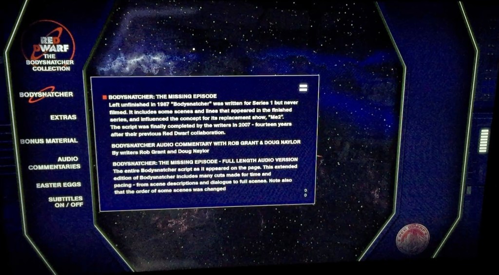 Menu for the Red Dwarf Bodysnatcher Blu-ray disc. Against a dark blue background on the left are options in white text for Bodysnatcher, Extras, Bonus Material, Audio Commentaries, Easter Eggs and Subtitles. The Bodysnatcher option is selected, revealing a large text box over a starry space background, with white text explaining the options for viewing the episode in its standard form with or without commentary, or a longer uncut version.