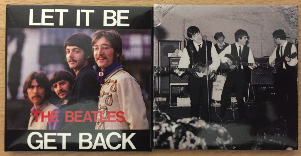 2 square fridge magnets featuring The Beatles. One shows the group posing together outdoors, while white text at the top and bottom says Let It Be and Get Back respectively. The other magnet shows a black and white photo of the band performing in a recording studio.