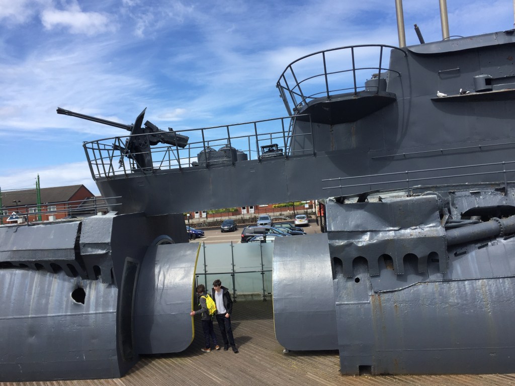 A section of the very large, grey U-534 submarine, with viewing platforms and a long-range gun on the two upper outdoor levels.