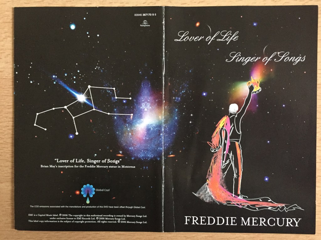 DVD cover for Freddie Mercury, Lover Of Life, Singer Of Songs. Features a drawn image of Freddie wearing a long flowing robe that drapes across the ground, while holding a crown in the air, looking out into space, surrounded by stars.