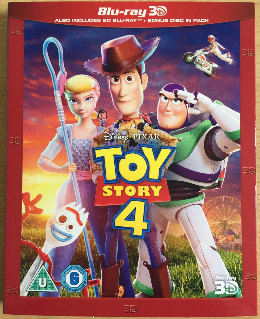 Blu-ray cover for Toy Story 4, showing Woody, Buzz, Bo Peep and Forky standing on a grassy hill with a ferris wheel in a fairground visible in the distance.