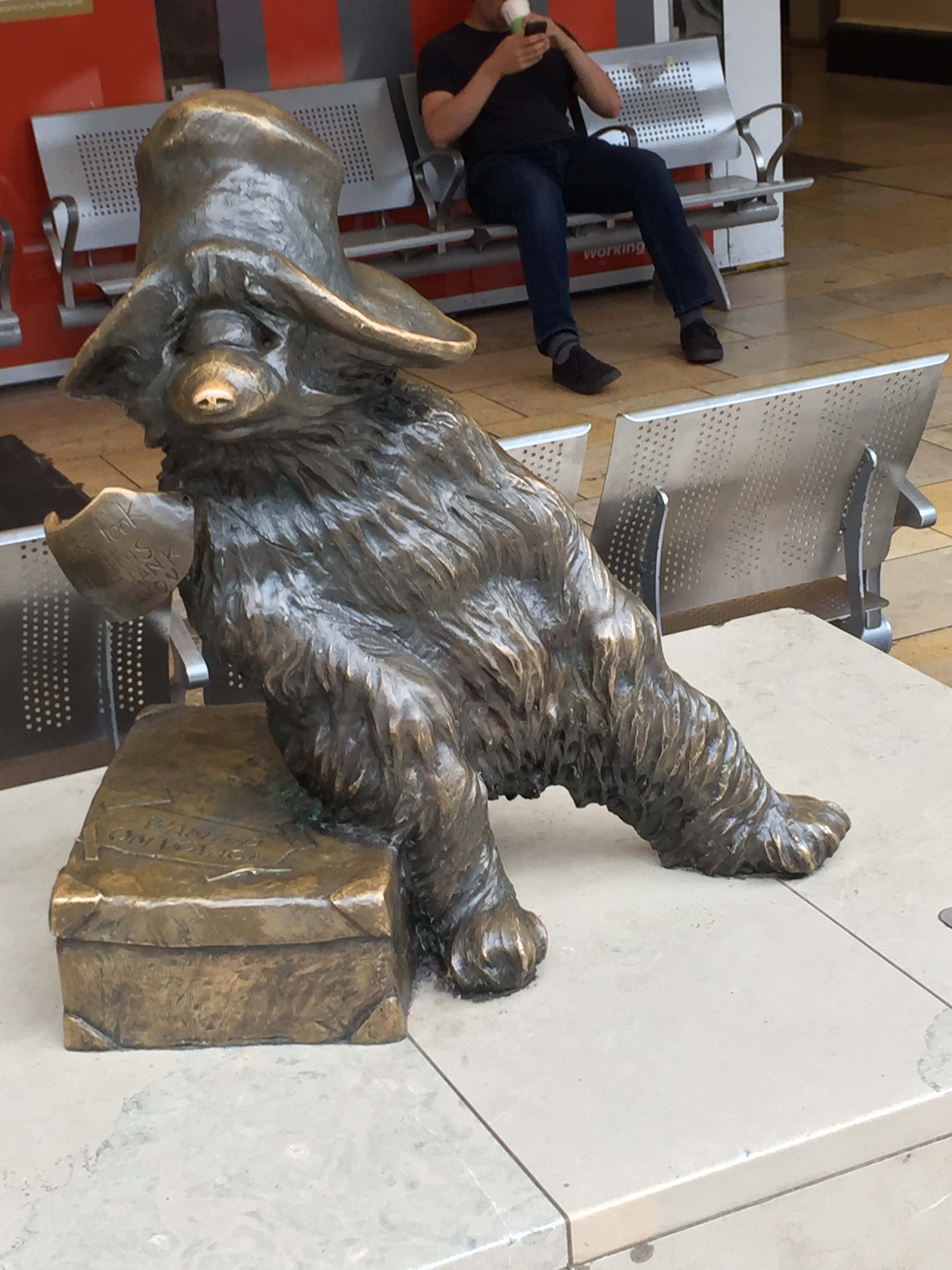 A life-size bronze statue in Paddington Station of Paddington Bear sitting on his suitcase.