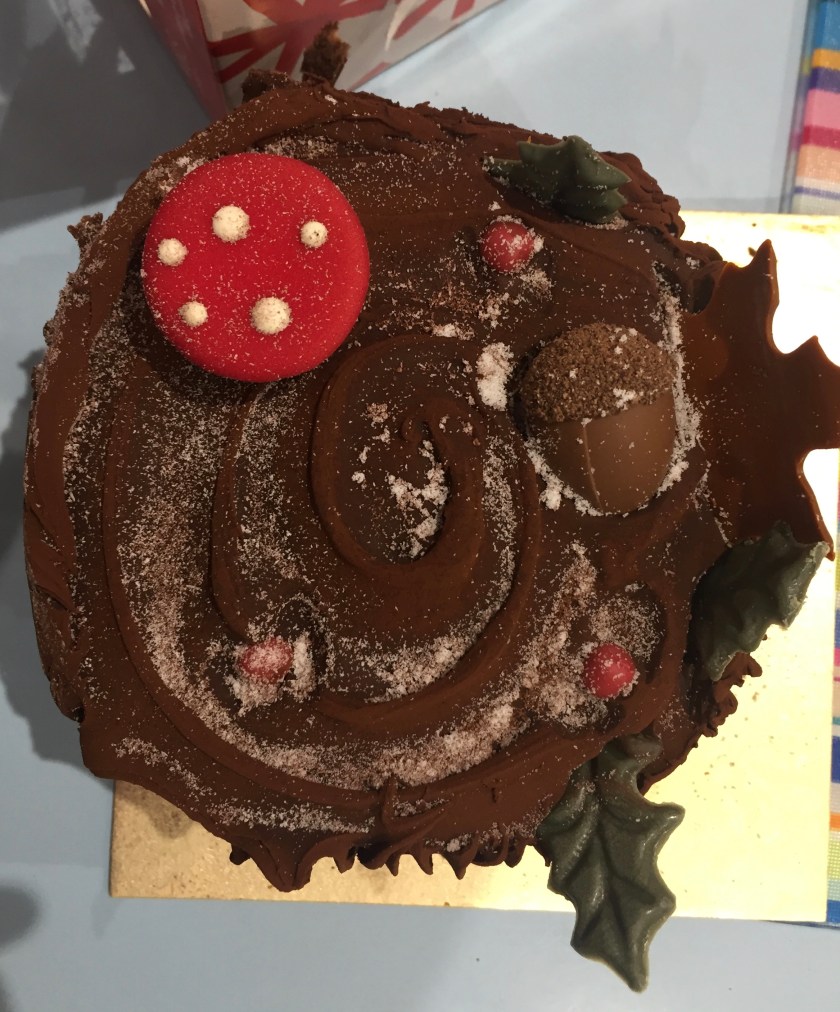 Large chocolate Yule Log from Marks & Spencer, with edible woodland decorations such as leaves and a toadstool sticking out of it.