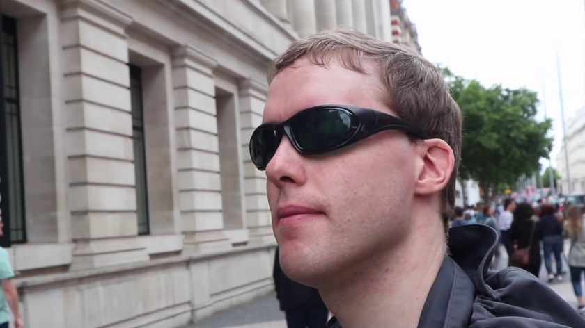 Close-up of Glen wearing his green-tinted sunglasses while standing outside the Science Museum.