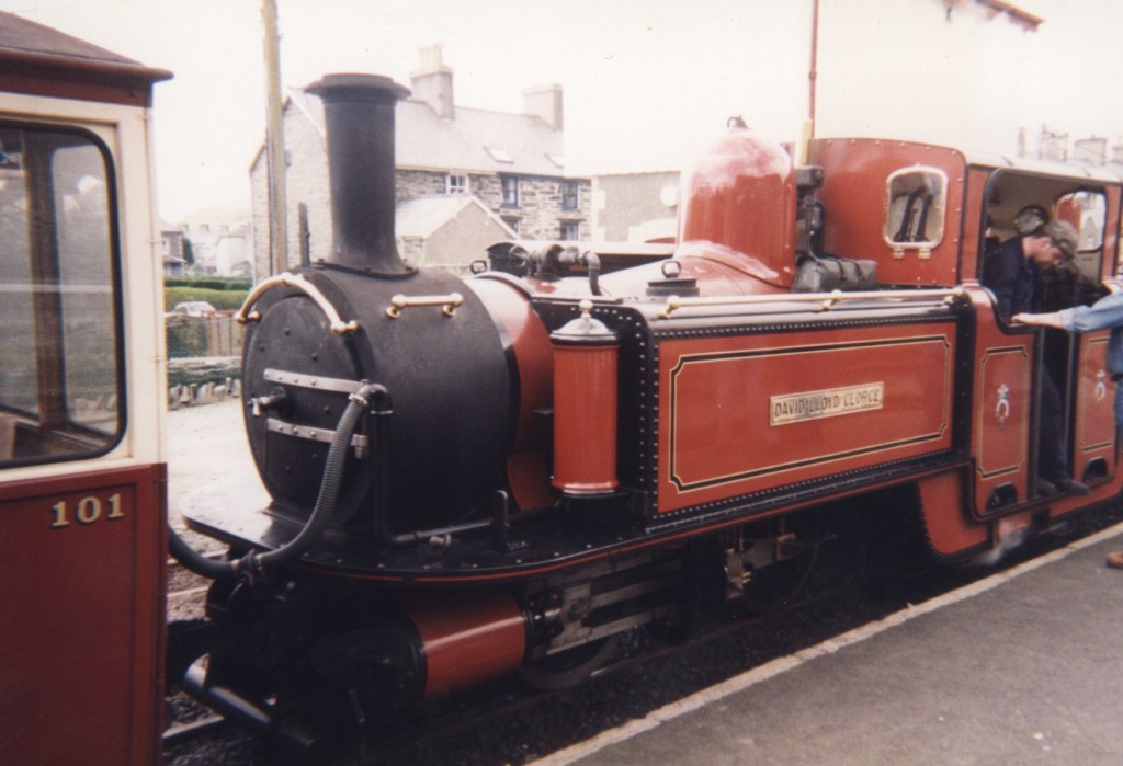 Red steam train, with the name David Lloyd George displayed on a metal panel on the side of the locomotive.