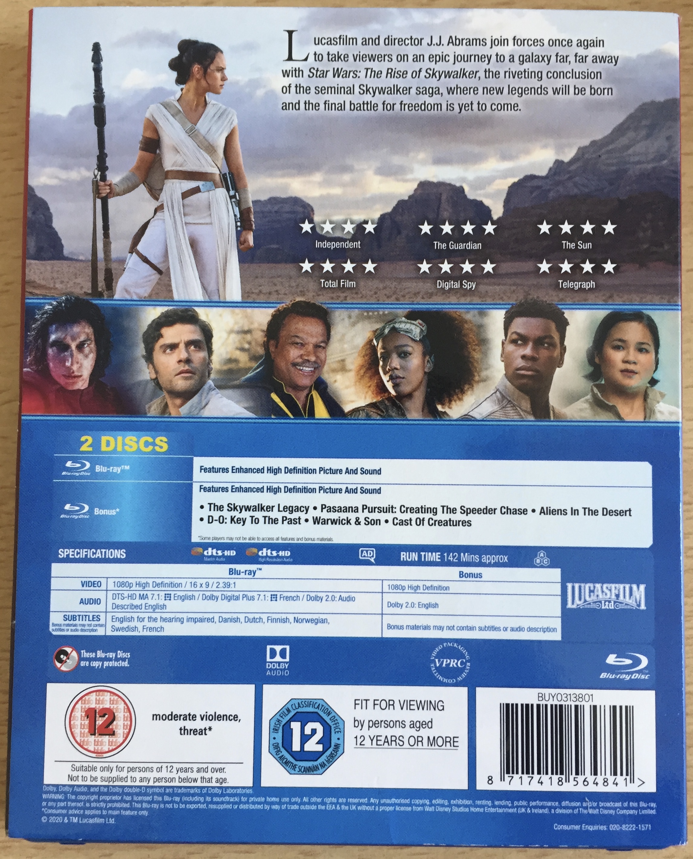 Blu-ray back cover for Star Wars Episode 9, The Rise Of Skywalker, showing Rey dressed in a white dress and holding a long staff as she observes the desert around her, below which is a row of photos of other characters.